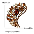 Vintage gold wing brooch with amber rhinestones measuring 9.1cm by 6.4cm for women - Brown