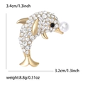 Golden dolphin brooch with sparkling crystals and white pearl, size dimensions included - Gold