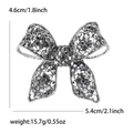 Vintage alloy bow brooch with rhinestones and hollow floral patterns, size 5.4cm x 4.6cm - Black (MM-BR-0391-BK)