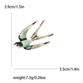 Exquisito broche de golondrina con esmalte verde y pedrería para trajes de mujer - Colorido