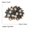 Vintage rhinestone hedgehog brooch with black and milky crystals on a gold setting - Gold
