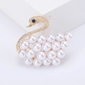 Elegant gold swan brooch featuring white pearls and matte finish on white platform - Gold