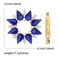Detail view of sunflower brooch showing 4.1cm size, blue gemstones and pin mechanism - KC Gold - Blue
