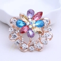 Colorful crystal flower brooch featuring purple and blue petals with rose gold plating - Rainbow