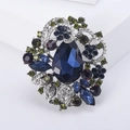 Luxurious bohemian flower brooch with blue crystal teardrop and green rhinestones - Ink Blue