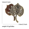 Luxury rhinestone leaf brooch in gold finish with red crystals and dimensions scale - Brown