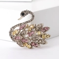 Detail of elegant colorful swan brooch with pink and champagne crystals on silver base - Colorful