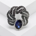 Vintage silver brooch with oval blue gemstone and dark crystal twisted ring design - Dark Blue