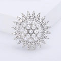 Elegant sunflower brooch featuring white pearls and sparkling rhinestones on silver metal - Silver