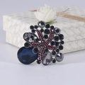 Vintage flower basket brooch featuring a large teardrop navy gemstone and silver base - Red