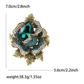 Vintage rose brooch with deep green crystal and blue rhinestones on gold alloy base - Green