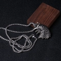 Detailed view of silver eagle head pendant with intricate feather texture on box chain - Silver