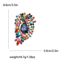 Modieuze broche met grote blauwe edelsteen en kleurrijke strass-steentjes in goud - Meerkleurig