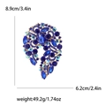 Deep blue crystal rhinestone brooch pin with gold alloy base and ornate scroll patterns - Blue