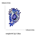 Vintage gouden legering broche met elegante blauwe kristallen en geslepen glasstenen - Blauw