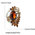 Vintage gold brooch featuring amber crystal center with champagne rhinestones and size guide - Coffee