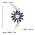 Luxury blue crystal flower brooch with white pearl center and gold-tone metal branches - Gold