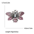 Detail view of rhinestone bee brooch with pink stones and dimensions 5.7cm x 4.0cm - Purple
