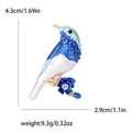 Blue enamel bird brooch with sparkling crystal flower detail, 4.3cm height dimension - Blue