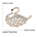 Elegant gold swan brooch with sparkling rhinestones and hollow patterns, 2.9x3.8cm - Gold
