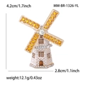 Detail view of enamel windmill brooch with dimensions 4.2cm by 2.8cm and crystal accents - Yellow
