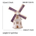Detailed view of enamel windmill brooch with purple petals and rhinestone center - Purple