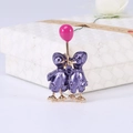 Detail of purple enamel duck brooches with pink balloon on a white gift box - Purple