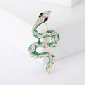 Exquisite snake-shaped brooch in gold alloy with green enamel and sparkling crystals - Green Spirit Snake