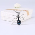 Detailed close-up of blue ant brooch with silver plating and crystal inlay work - Blue Black