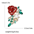 Elegant rose brooch with red crystals, green leaves, and pearl in golden finish - Red