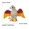 Golden eagle brooch with red and yellow enamel wings and sparkling white crystals - Red