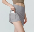 Detail of high-waisted grey sports skirt with side pocket holding a smartphone - Moon Rock Grey
