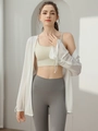 Loose white yoga cover-up jacket with long sleeves and drawstring cuffs on model - White