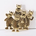Detailed macro of vintage golden cow brooches with textured finish and crown details - Gold