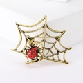 Detailed close-up of retro bronze spider web brooch with vibrant red rhinestones - Ancient Gold (MM-BR-1683)