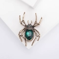 Broche araignée dorée vintage avec grand cristal vert et pattes squelette pour Halloween - Vert