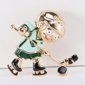 Macro detail of enamel hockey player brooch with golden helmet and green jersey - Green