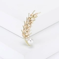 Elegant wheat stalk brooch with champagne crystals and a white pearl on a stone stand - Champagne