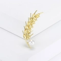 Macro shot of gold wheat brooch with yellow crystals and elegant white pearl detail - Yellow
