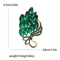 Spilla a fiore vintage con cristalli verdi, fiocco dorato e strass eleganti - Verde