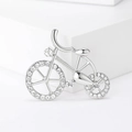 Silver bicycle brooch with sparkling white crystals on a white geometric stand - Silver (MM-BR-2095)