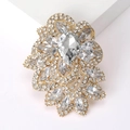 Macro view of pear-cut crystal brooch with sparkling marquise stones on gold base - Gold