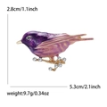 Purple enamel bird brooch on rhinestone branch measuring 5.3cm with 9.7g weight - Purple
