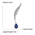 Elegant wing-shaped brooch with blue crystal drop and diamond-encrusted silver finish - Silver with Deep Blue Pendant