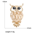 Chic golden alloy owl brooch with cat eye stones and black gem eyes, size 4.4cm by 2.5cm - KC Gold (MM-BR-2255)