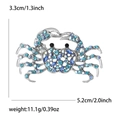 Broche crabe vintage avec cristaux bleus sur alliage argenté, 5.2cm x 3.3cm - Bleu