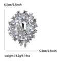 Elegant silver alloy sunburst brooch with clear crystals and rectangular center stone - Silver