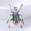 Vintage silver beetle brooch featuring purple-green enamel wings and white rhinestones - Purple
