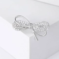 Exquisite silver bowknot brooch with zircon inlay on a minimalist white display - Silver