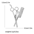 Detailed view of silver-tone scissor and comb brooch with sparkling zircon stone - Silver
